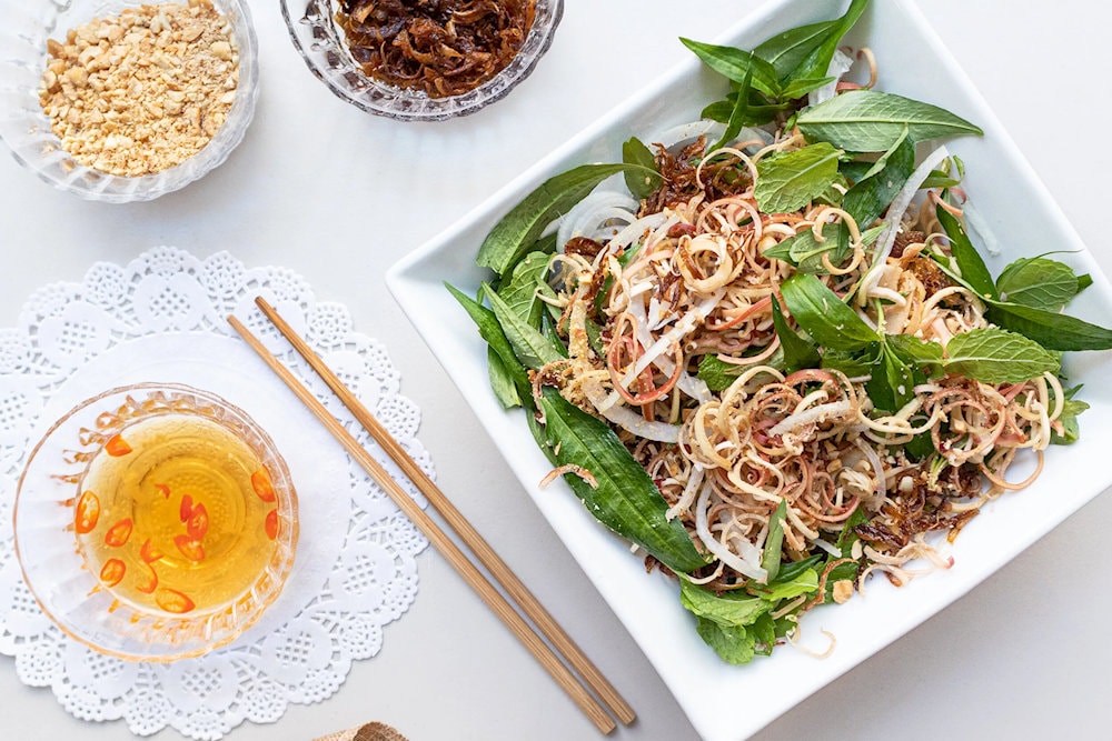 Banana flower salad with harmonious sweet, sour, salty, and spicy flavors, crunchy banana flowers mixed with herbs, creating a unique and attractive flavor